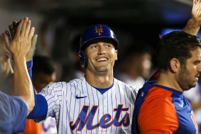 Mets outfielder Brandon Nimmo celebrates in the dugout. He could help solve the SF Giants defensive woes.